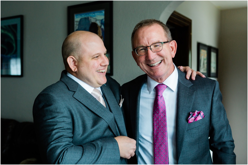 Groom laughing with his father-in-law to be before the wedding