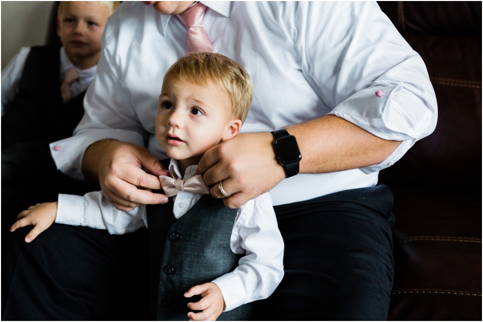 dad tying bow tie for ring barer
