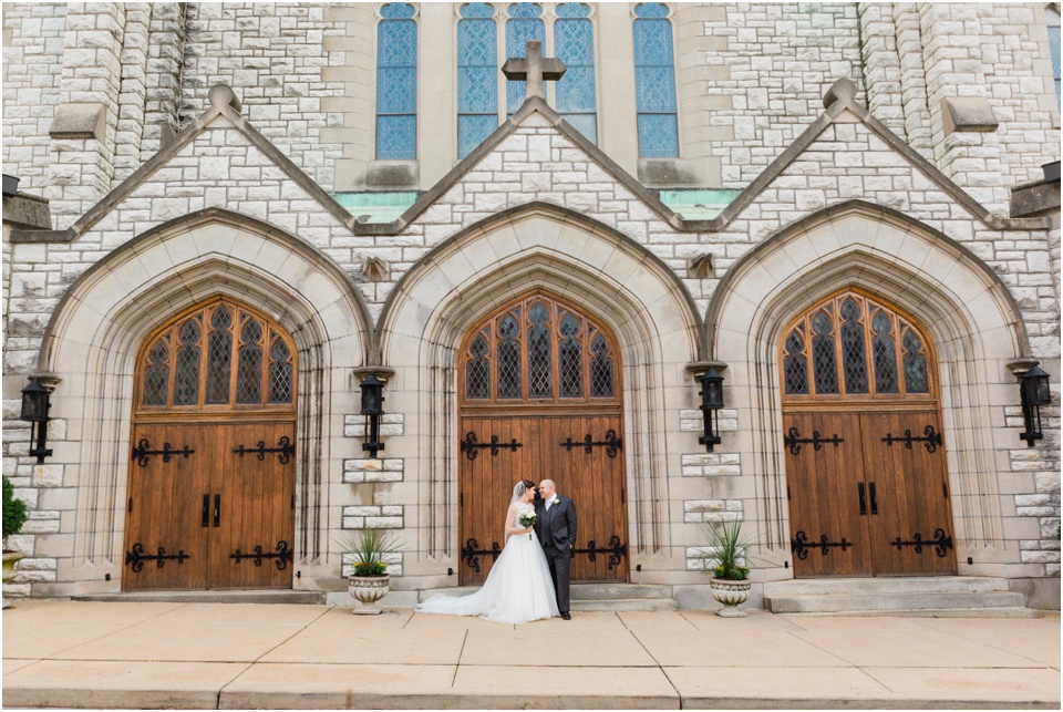 Bride and groom standing in front of St. Margaret of Scotland Church in Shaw neighborhood