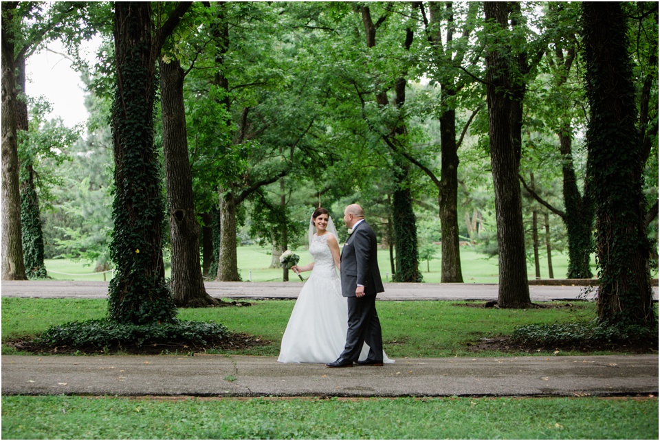 Bride and groom walking through Tower Grove Park