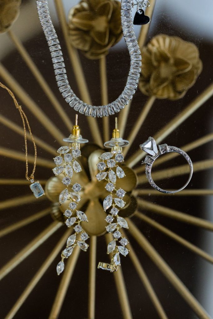 Bridal jewelry on a gold and glass table surface